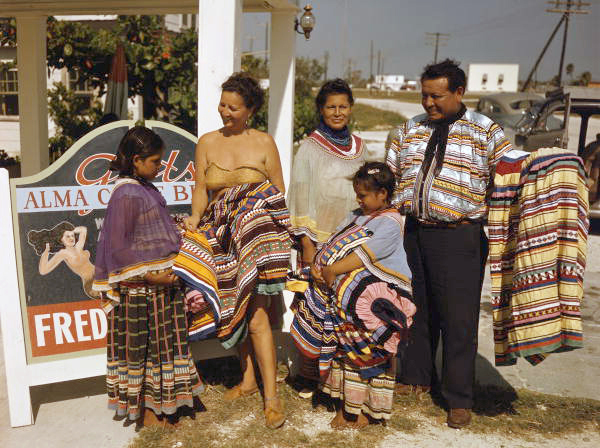 Seminole family selling patchwork clothing by Lake Okeechobee near the Brighton Indian Reservation.