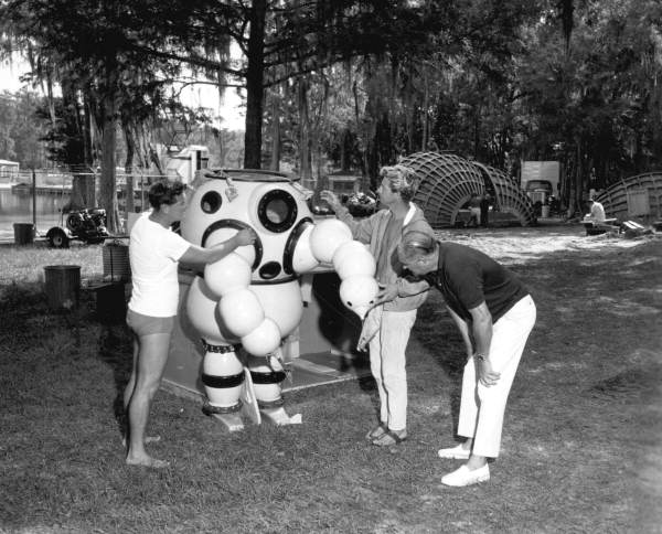 Unidentified men check diving equipment used in Around the World Under the Sea - Wakulla Springs, Florida.