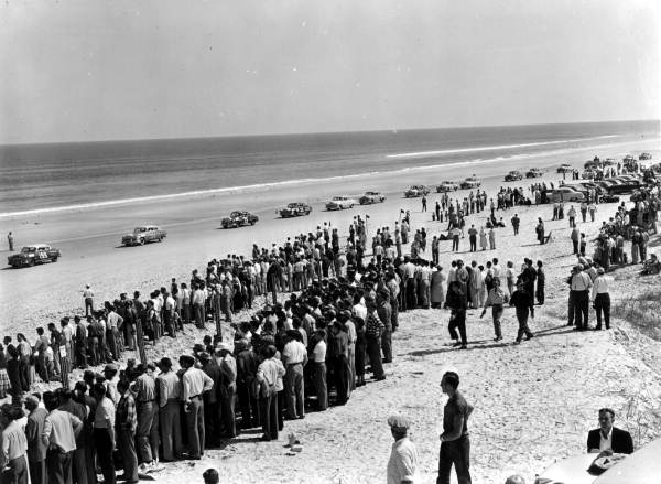 Crowds watching race cars lined up on beach - Daytona Beach, Florida