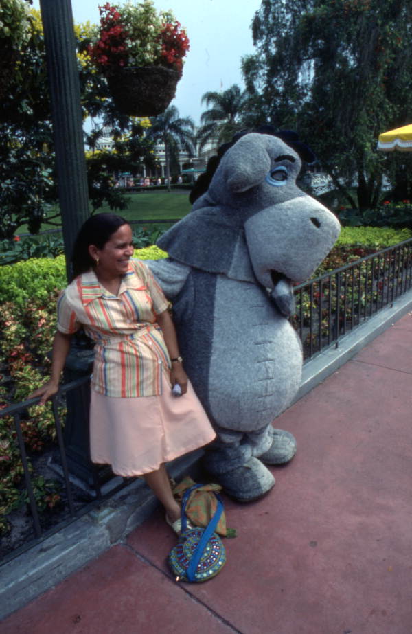 Visitor meeting Eeyore at the Magic Kingdom amusement park in Orlando, Florida.