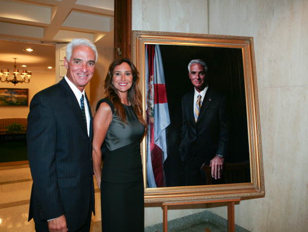 Former governor Charlie Crist standing with his wife Carole next to his official portrait during an unveiling ceremony in Tallahassee, Florida.