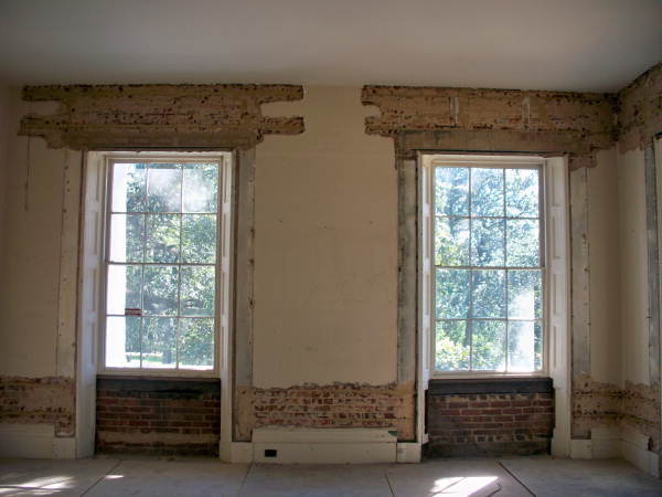 Interior view showing a brick wall prepared for restoration at the historic Call-Collins House museum at The Grove in Tallahassee, Florida.