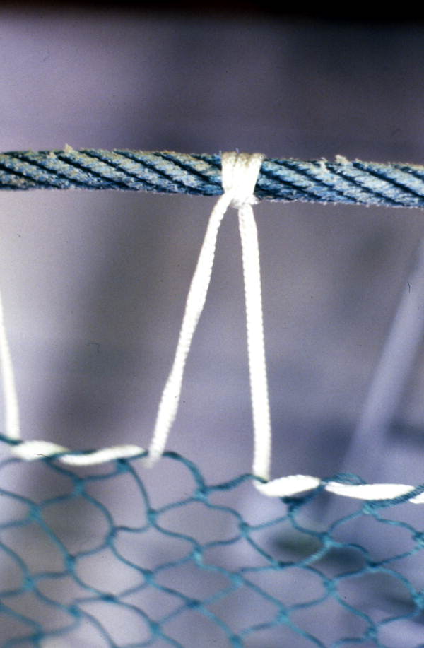 Detailed view of a fishing net being knitted by Rickey Doublerly - Jacksonville, Florida