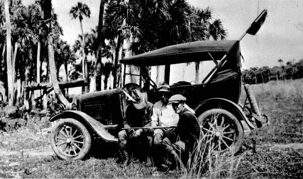 Surveyors with guide at a Seminole village near Alford City