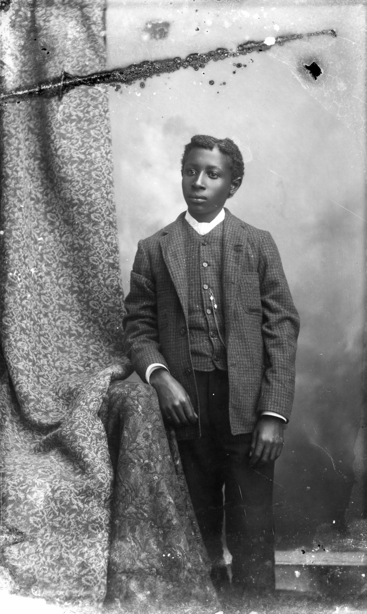 Young man in plaid coat and vest