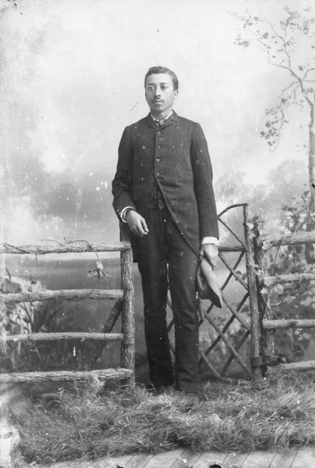 Man holding his hat at his side