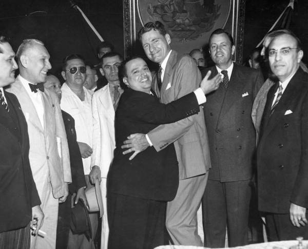 Governor Millard Caldwell and Governor Gouzales-Begta hug 
