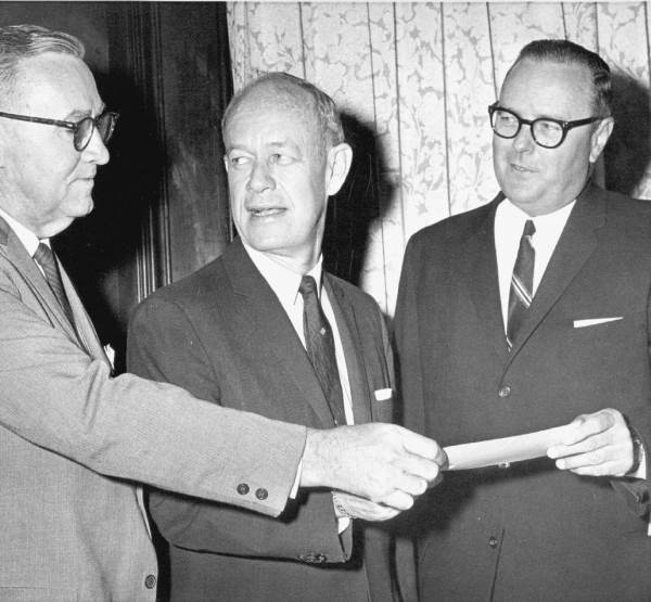 Florida Governor Farris Bryant and men passing a check