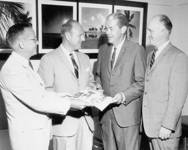 Florida Governor Haydon Burns sharing a pamphlet