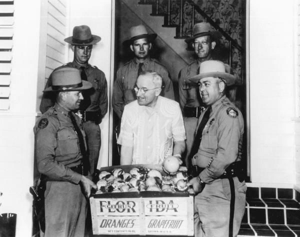 President Harry S. Truman receiving fresh fruit from Florida Highway patrolmen - Key West Florida