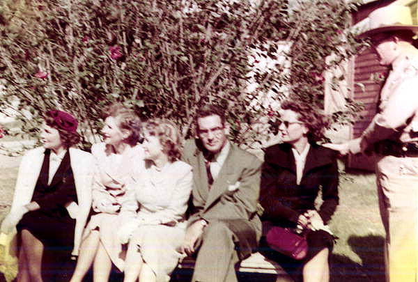 Governor Dan McCarty and his wife sitting with unidentified women