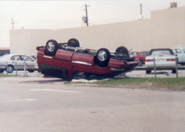 View of minivan overturned by Hurricane Andrew - Miami, Florida