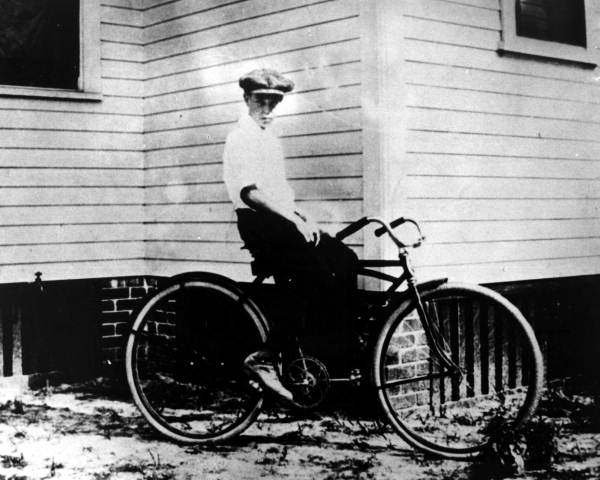 12-year-old Haydon Burns on bicycle at the corner of a house