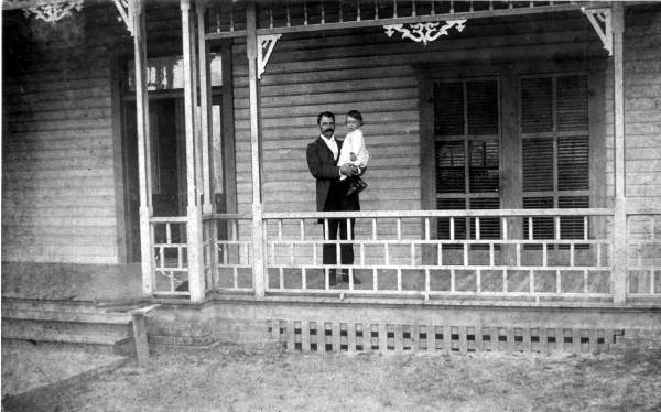 Willaim S. Jennings holding 18-month-old son on porch of his home - Brooksville, Florida