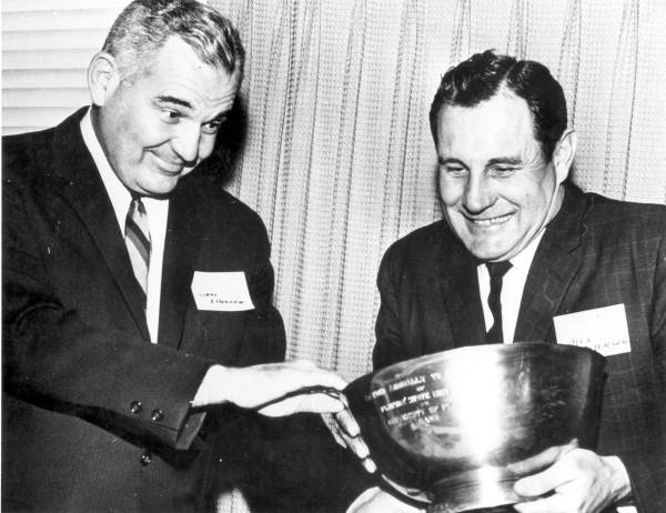 Two football coaches struggle to grasp a trophy - Tallahassee, Florida