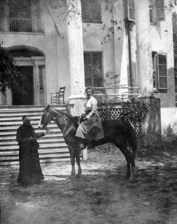 Ellen Call Long leads a horse ridden by a lady in front of "The Grove" - Tallahassee, Florida
