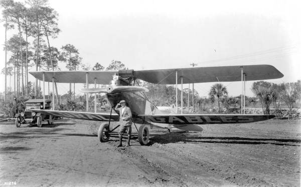 Man posing in front of a biplane, part of Mabel Cody's Flying Circus - Coral Gables, Florida