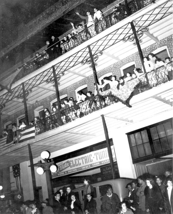 Parade viewers on balconies of building west of Las Novedades Restaurant in Ybor City - Tampa, Florida