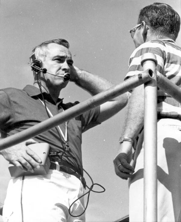 UF football coach Graves testing portable telephone - Gainesville, Florida