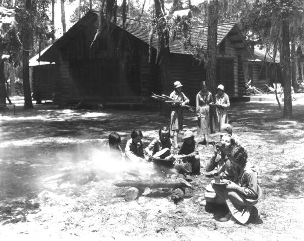 Girl Scouts at a Camp having a cookout
