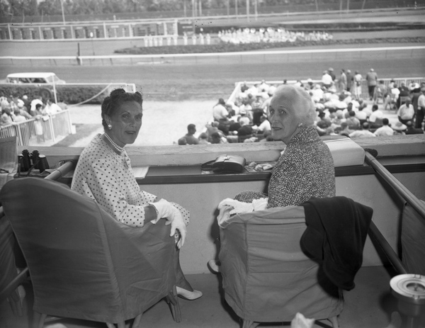 Mrs. Edward F. Hutton (later Weir), left, with unidentified woman at the Hialeah Racetrack.