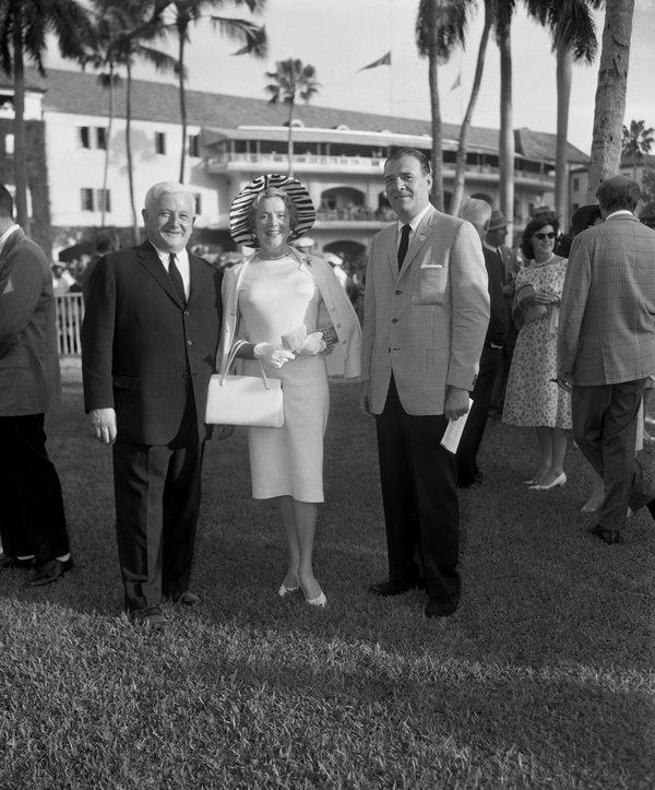 President of Hialeah Racetrack Eugene Mori, left, with actress Mrs. Stephen Sanford and Cmdr. Harold Crossman.