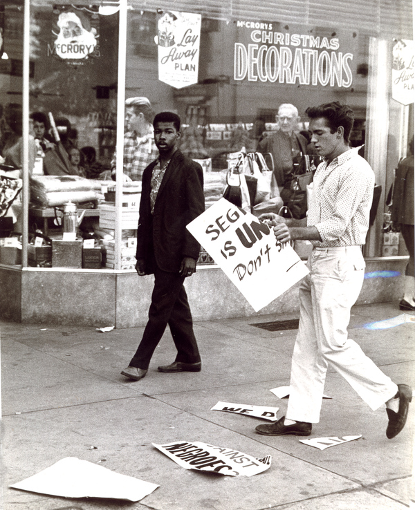White youth ripping poster during demonstration at McCrory's in Tallahassee.