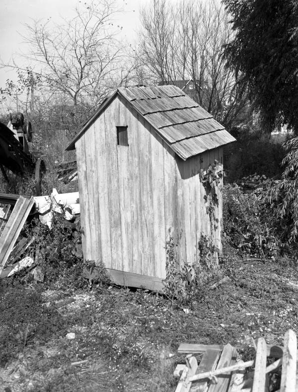 Rear view of an outhouse.