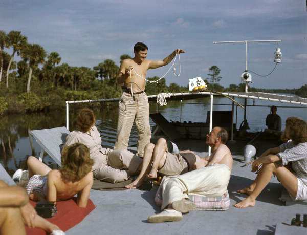 Joe Steinmetz performing a magic trick aboard the shantyboat "Lazy Bones".