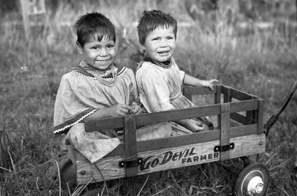 Seminole children in a toy wagon at the Brighton Indian Reservation.