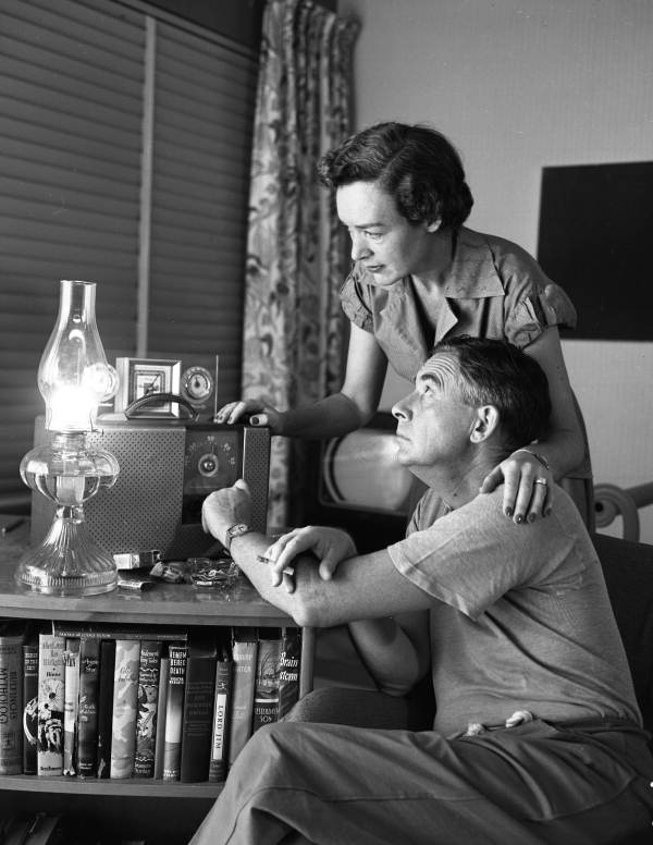 Philip Wylie with his wife listening to the radio for weather reports in Miami, Florida.