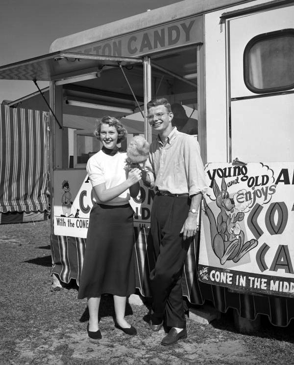 Sarasota High School notable students Kathryn Summers and Ernie Thomas posing with cotton candy in Sarasota, Florida.
