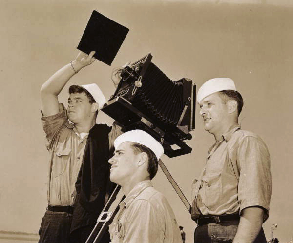 Naval Photography School students with camera on a tripod at NAS Pensacola.