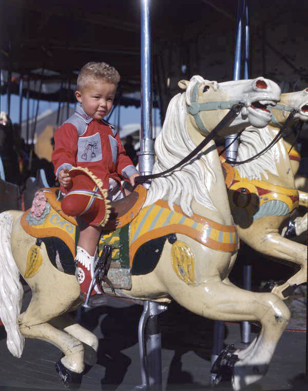 Young rider on a merry-go-round in Taos, New Mexico.