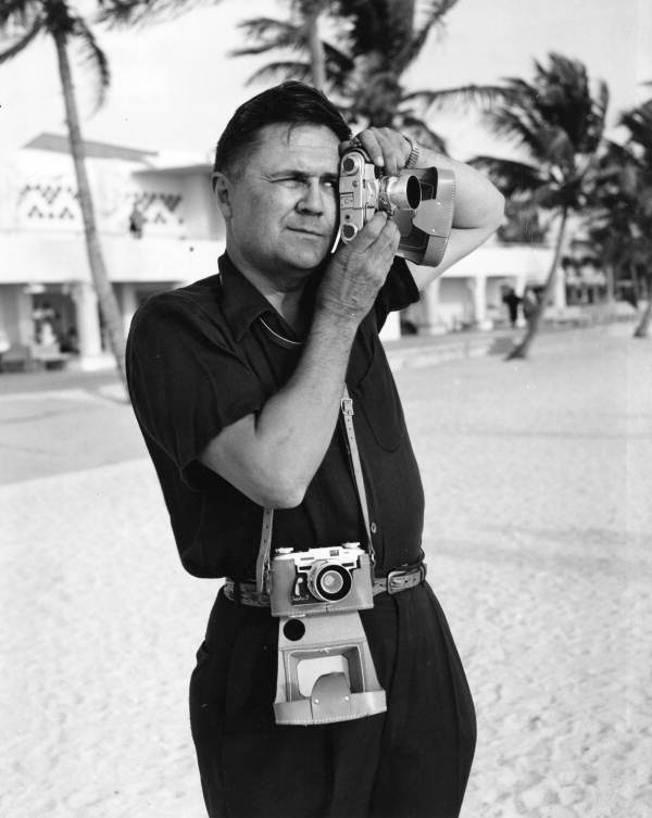 Joe Steinmetz testing the new Graflex 35mm camera near the municipal casino on Lido Beach, Florida.