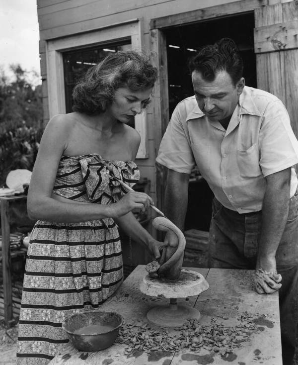 Mr. and Mrs. William Tracy, an active couple in the art community of Sarasota, shown modelling a clay figure.