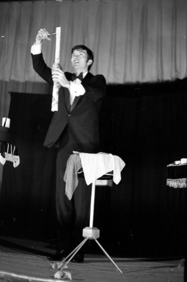 Magician on stage doing his act during a magic show at the Sarasota Jr. High School.