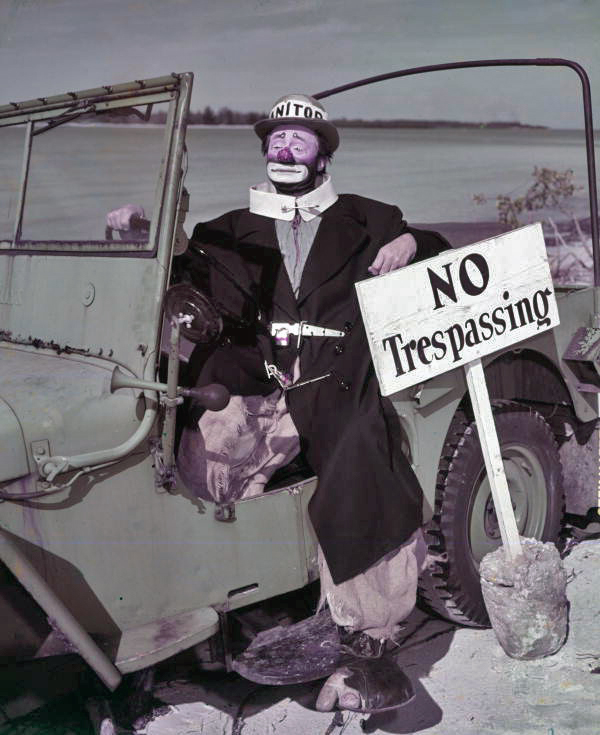 Outdoor portrait of Ringling Circus clown Paul Jerome sitting in a jeep on the beach.