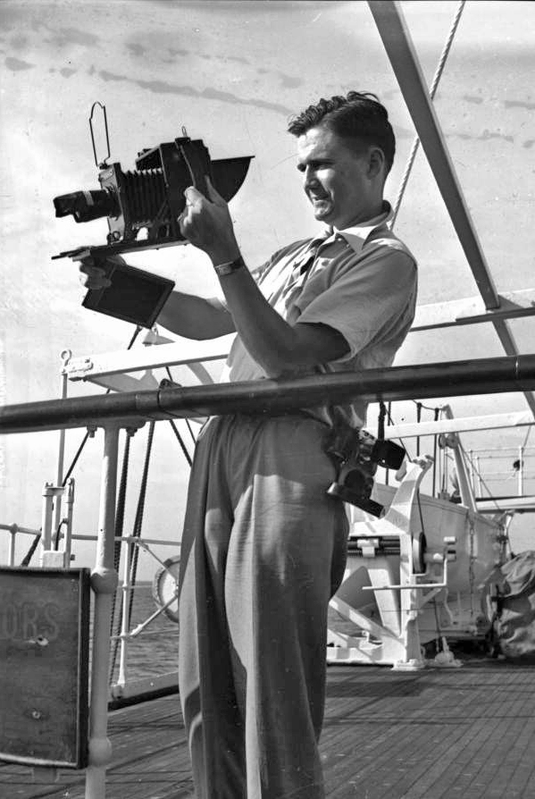 Photographer Joe Steinmetz taking a photograph on board a ship traveling to Guatemala.