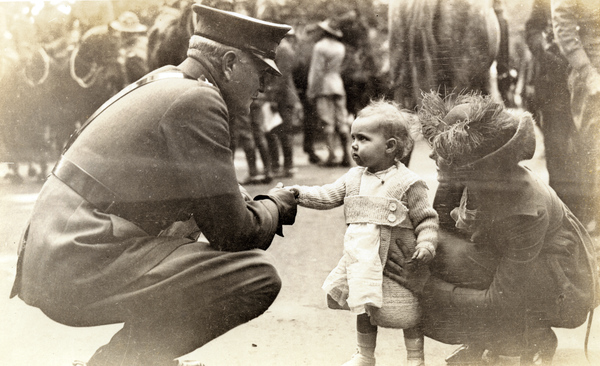 General Pershing with young visitor at a parade in Washington, D.C.