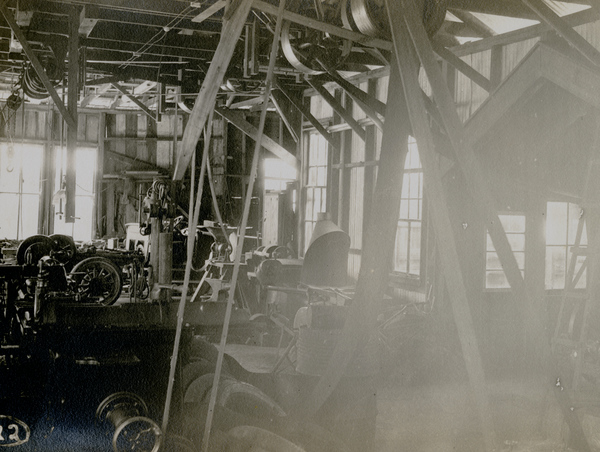 Postcard showing the inside of the Koreshan Unity machine shop.