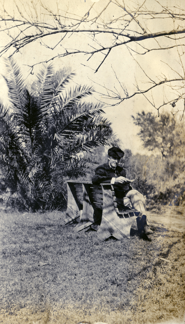 Unidentified Koreshan reading outdoors.