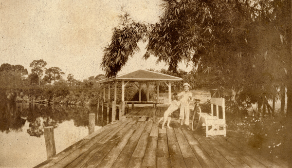 Koreshan boy with dog at Bamboo Landing in Estero, Florida.