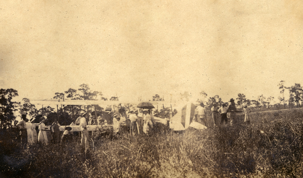 Crowd viewing an airplane.