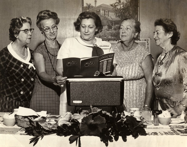 Members from the Florida League of Women Voters looking over a UNICEF booklet.
