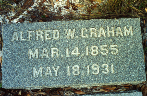 Close-up view of headstone for Alfred W. Graham in the Koreshan Unity cemetery at the Koreshan State Historic Site park in Estero, Florida.