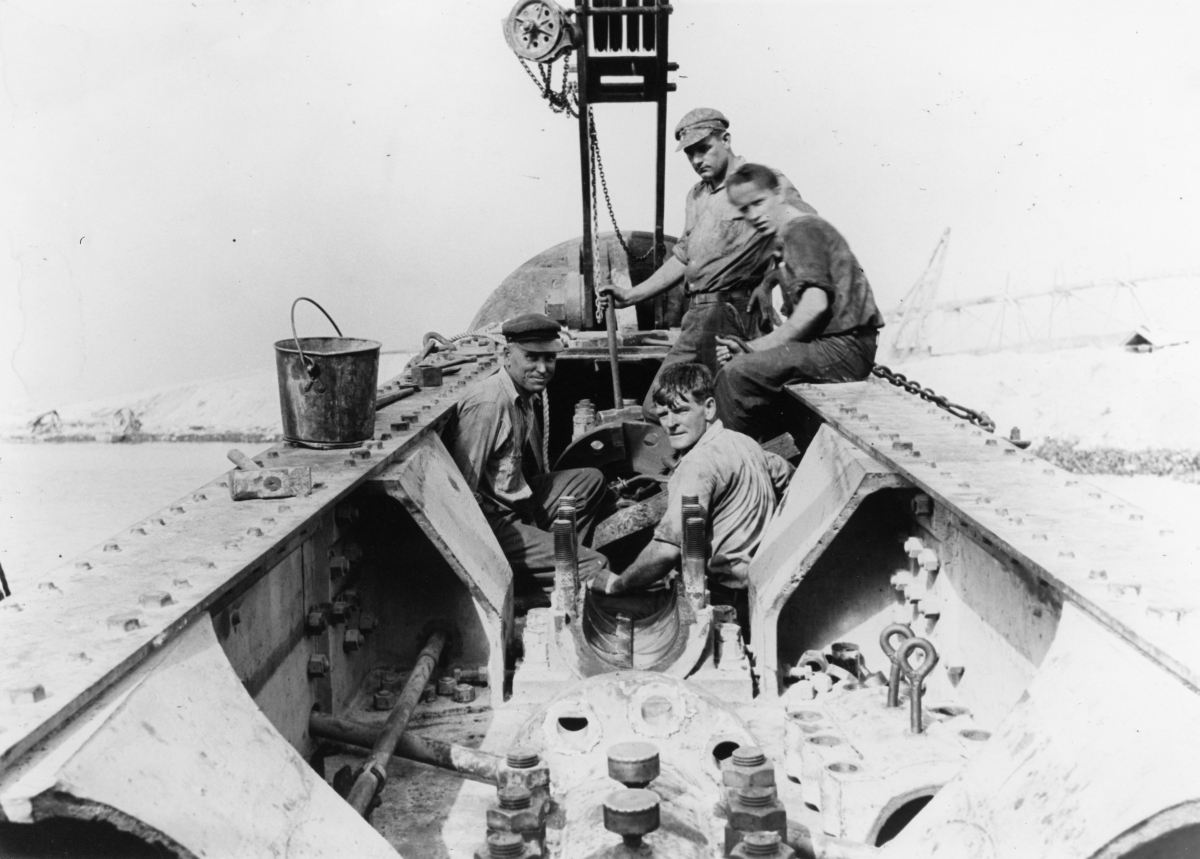 Close-up view showing construction workers assembling dragline near Lake Okeechobee.