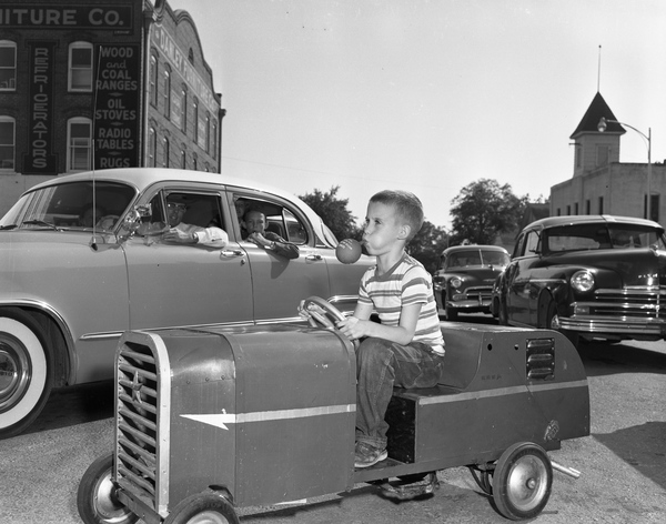 Boy with his home-built midget auto in the Quincy parade.