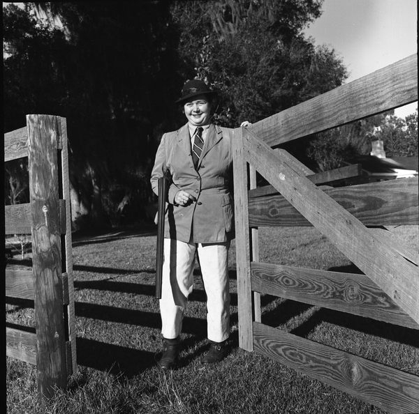 Portrait of Mrs. Julien Headley with her gun at a hunt in Tallahassee.