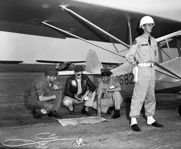 Men looking over map during a Civil Air Patrol search and rescue exercise.